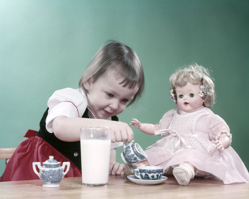 1950s Little Girl And Baby Doll Having Tea Party posters prints by Corbis