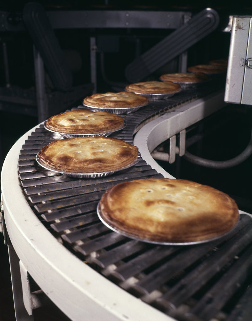 1970s Pies On Conveyor In Bakery by Corbis