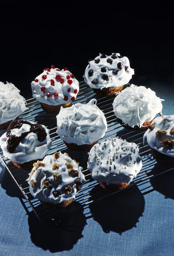 Detail of 1950s Cupcakes White Icing Decorations Chips Jimmies Nuts On Metal Cooling Rack by Corbis