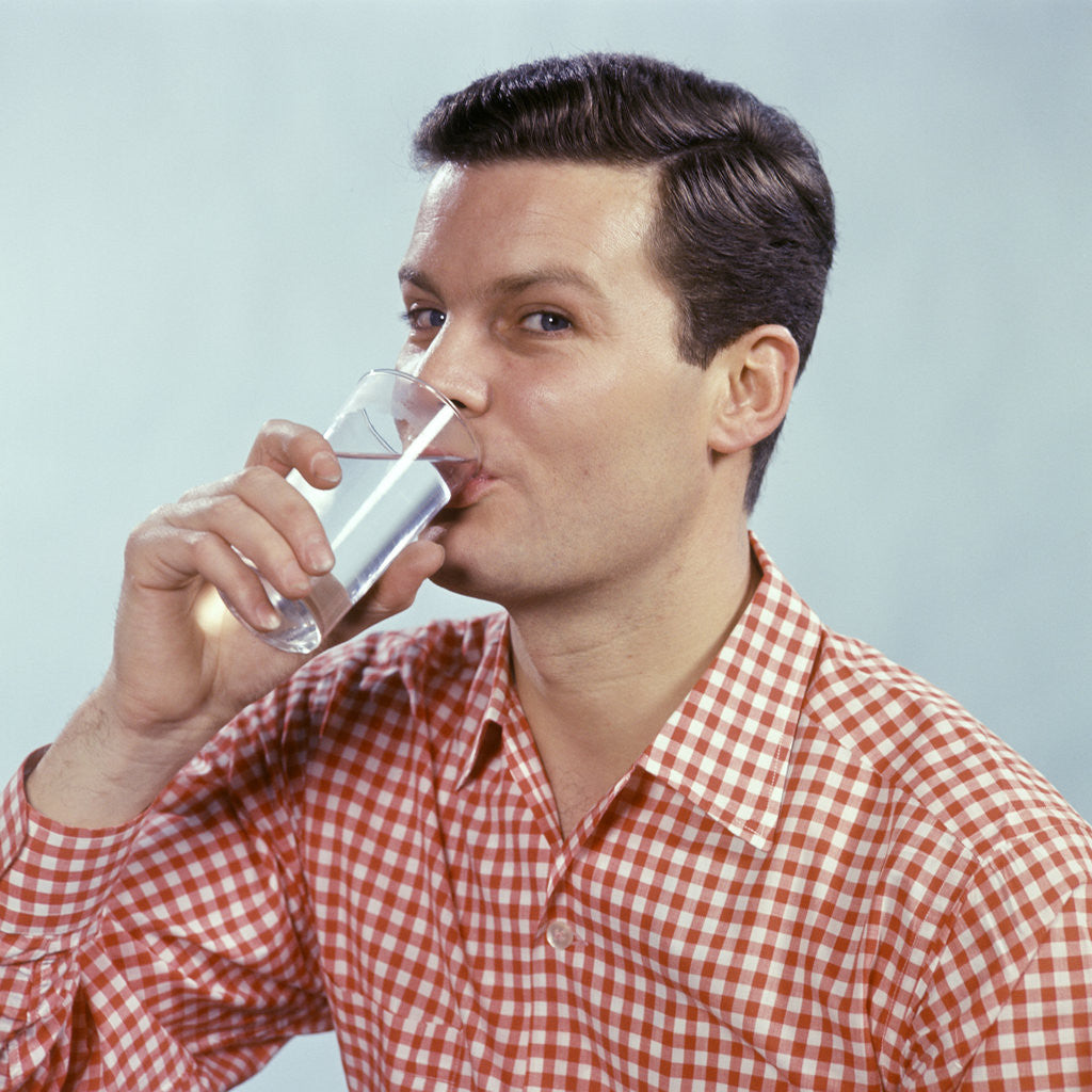 Detail of 1960s Man Drinking Glass Water Wearing Red Checkered Shirt by Anonymous
