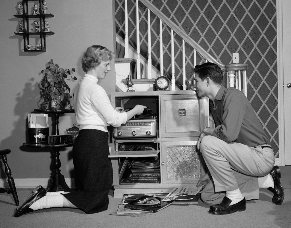 Detail of 1950s Teenage Couple Playing Hi-Fi Records On Console Phonograph In Living Room by Anonymous