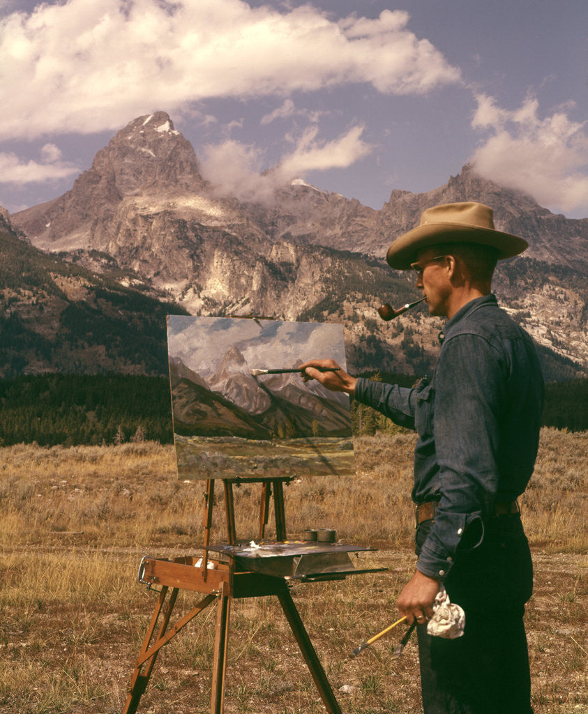 Detail of 1950s 1960s Man Artist Smoking Pipe Painting Mountain Landscape Grand Tetons Wyoming by Corbis