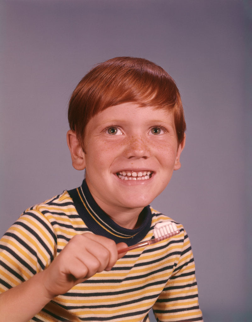 Detail of 1960s Happy Boy Red Hair Striped Tee Shirt Holding Toothbrush Brushing Teeth by Anonymous
