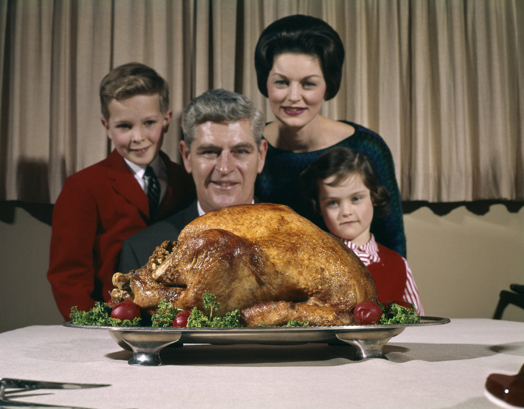 Detail of 1960s Portrait Of Family Looking At Thanksgiving Or Christmas Roast Turkey by Corbis
