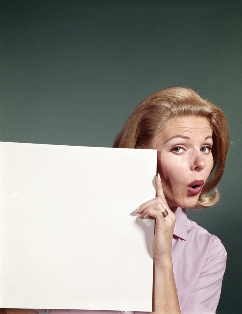 Detail of 1960s Portrait Of Surprised Woman Peeking Around Sign Board by Anonymous