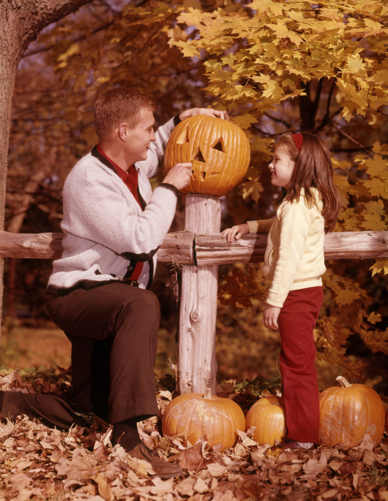 Detail of 1960s Man Father And Girl Daughter Carving Halloween Jack-O-Lantern Pumpkin by Corbis