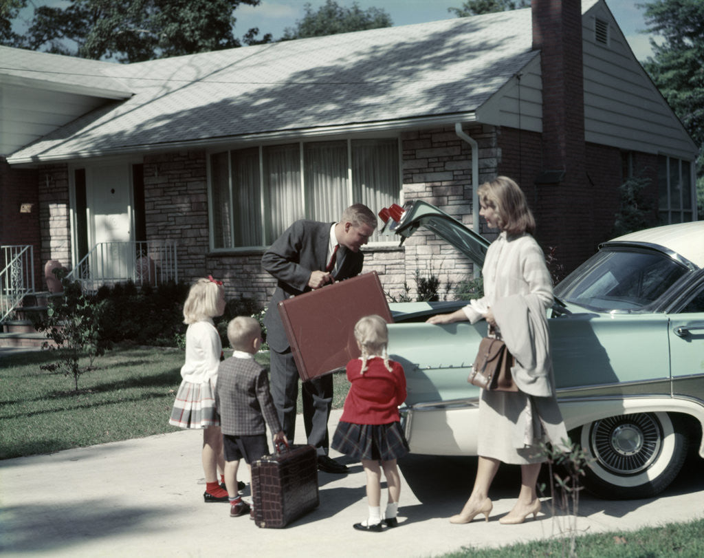 Detail of 1950s 1960s Suburban Family Loading Ford Four Door Sedan Automobile For Trip by Corbis