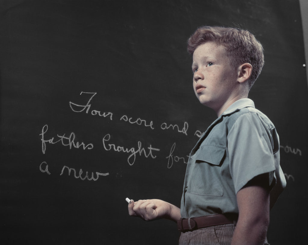 Detail of 1950s Boy with Freckles At History Class Blackboard Writing Gettysburg Address With Chalk by Corbis
