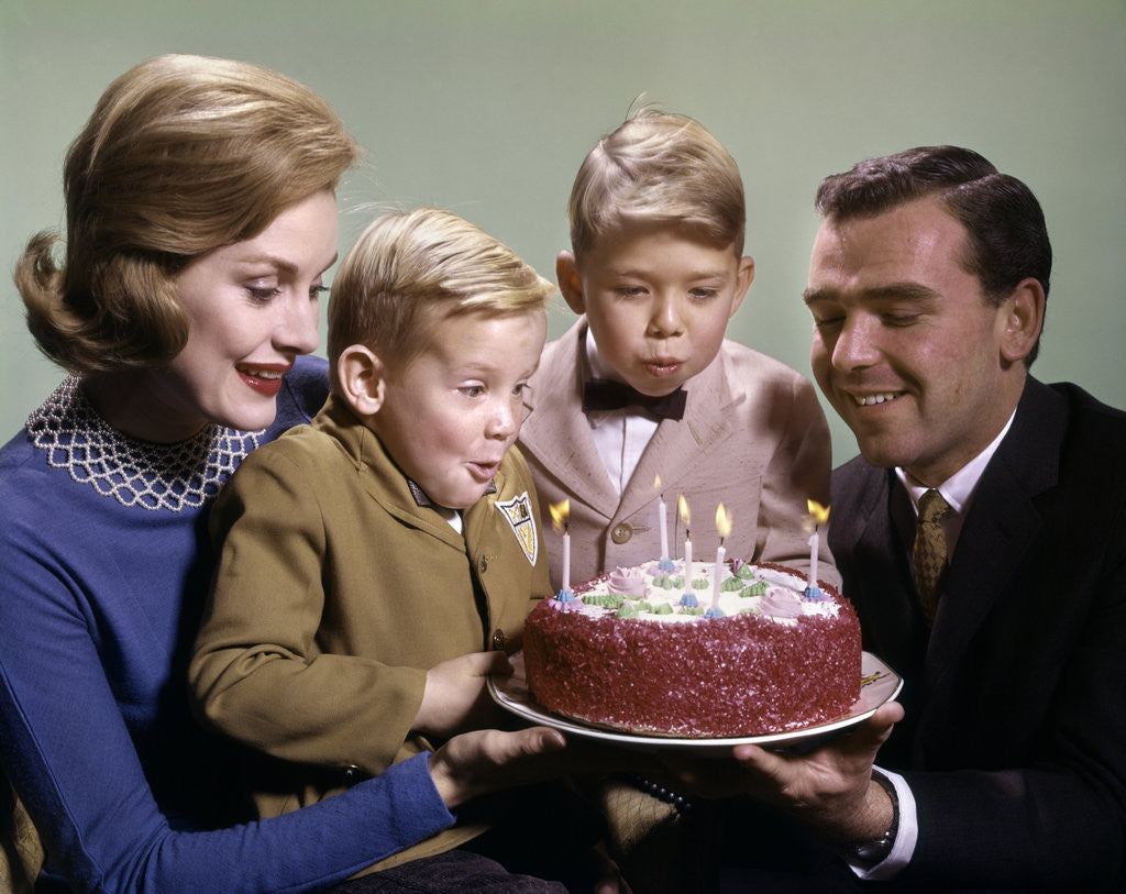 Detail of 1960s Mother And Father Holding Birthday Cake And Sons Blowing Out Candles by Anonymous