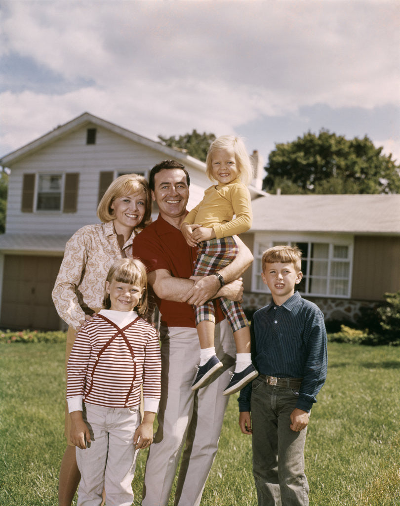 Detail of 1960s Family In Front Of A Suburban Split Level House by Corbis