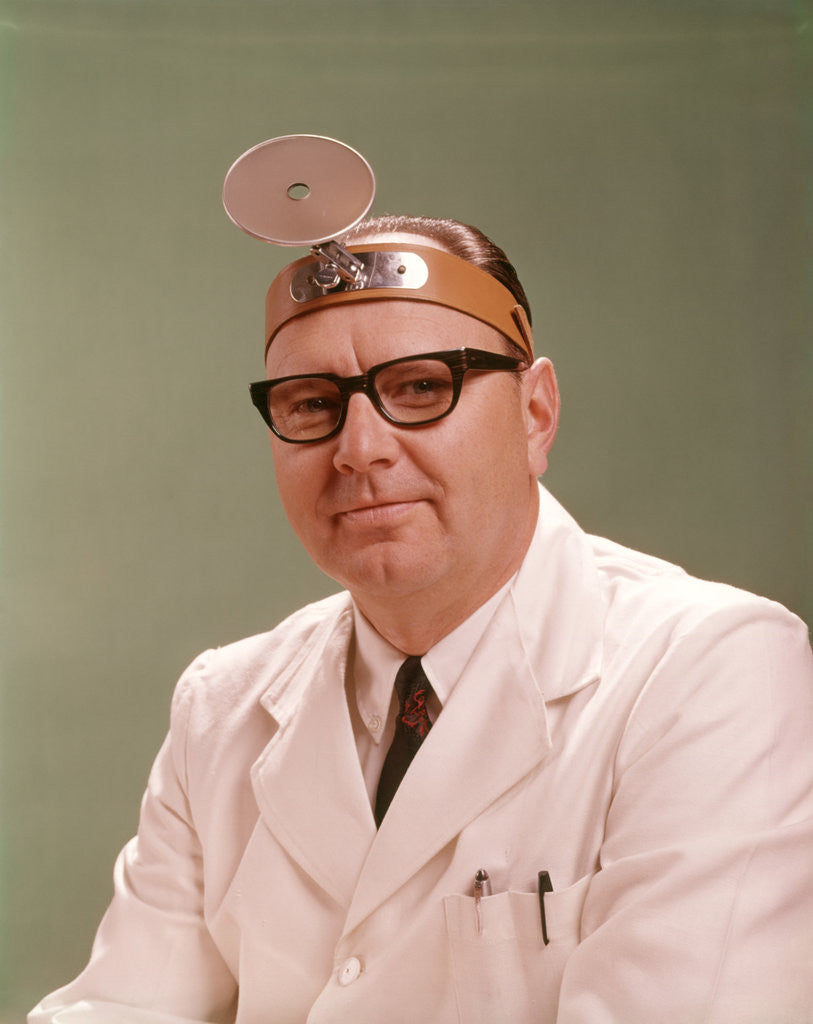 Detail of 1950s 1960s Doctor Wearing Diagnostic Head Mirror On Forehead by Anonymous