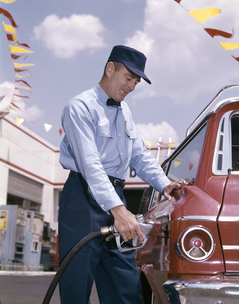 Detail of 1950s 1960s Service Station Attendant With Gasoline Pump Hose Filling Gas Tank Of Automobile by Anonymous