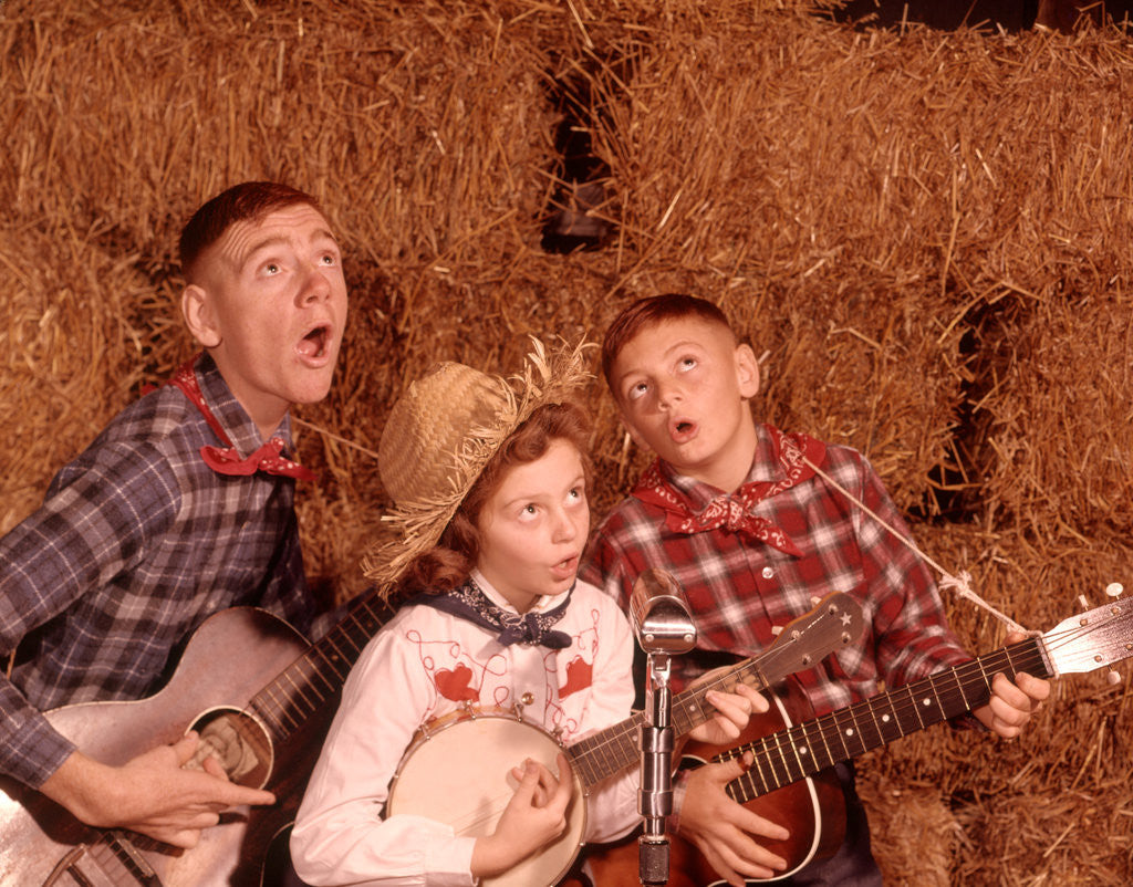 Detail of 1950s 1960s Two Brothers And A Sister Playing Instruments Guitars And Banjo Singing Country Music by Anonymous