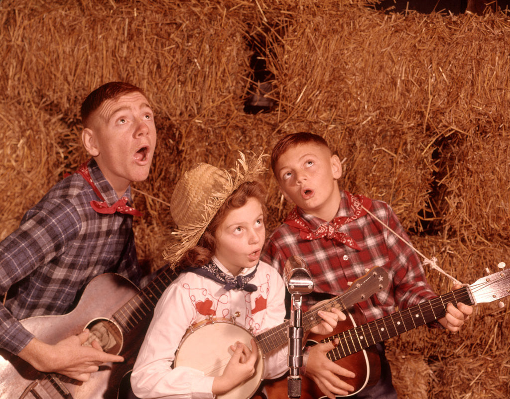 Detail of 1950s 1960s Two Brothers And A Sister Playing Instruments Guitars And Banjo Singing Country Music by Corbis