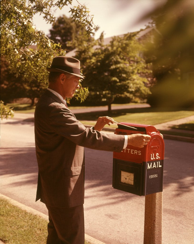 Detail of 1960s Man Business Man Suit Hat Mailing Letter Mailbox Mail Drop Box Post Postal Suburban Street by Anonymous