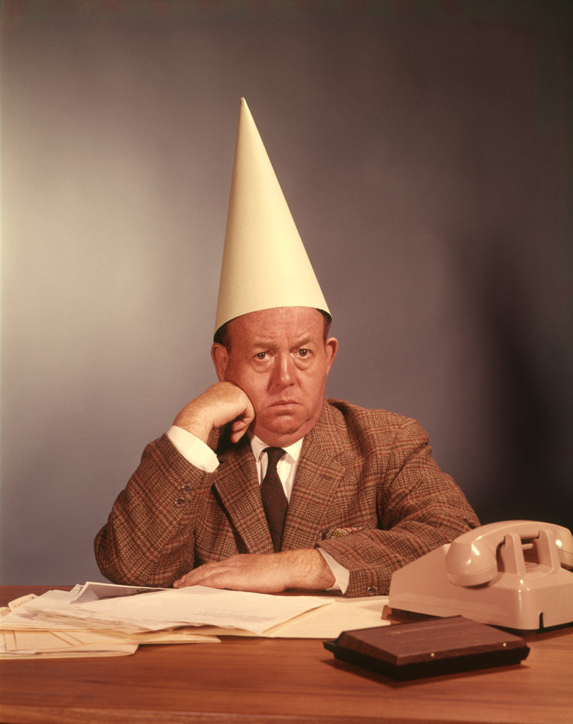 Detail of 1960s Sad Depressed Businessman Wearing Dunce Cap by Anonymous