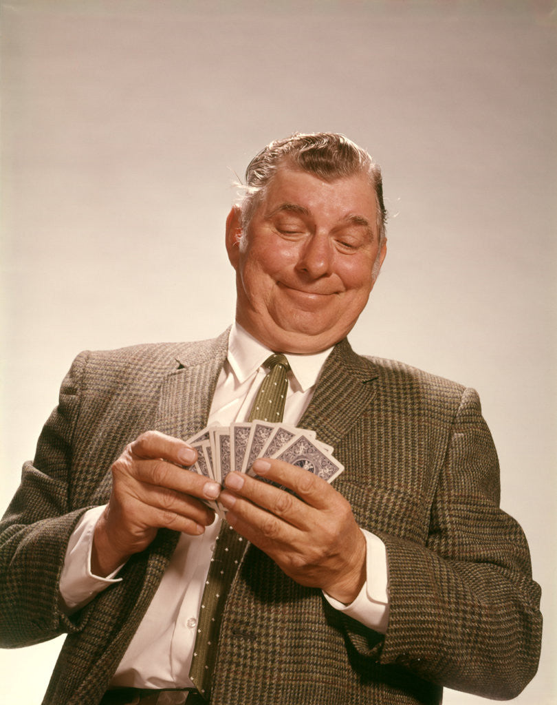 Detail of 1960s Satisfied Man Looking At Hand Of Playing Cards by Anonymous