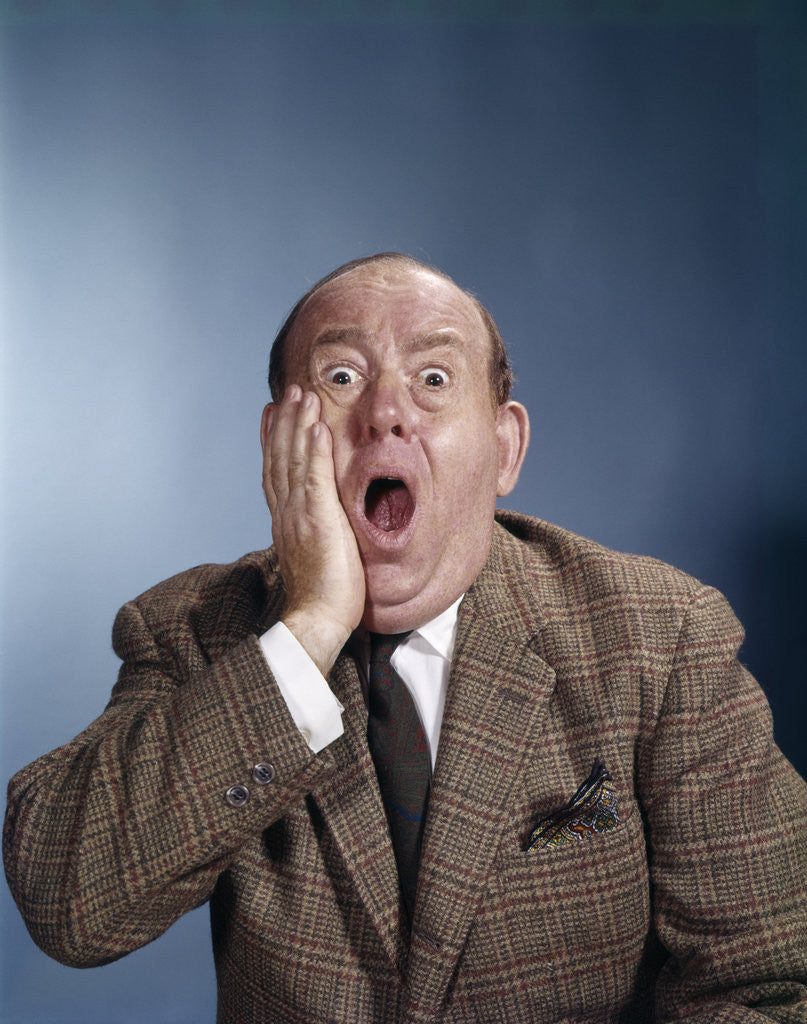 Detail of 1960s Balding Businessman Holding Hand Up To Face Shocked Expression Eyes Bulging Mouth Open by Anonymous