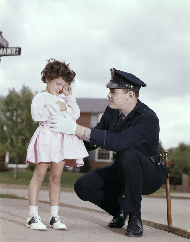 Detail of 1960s Man Police Officer Comforting Crying Scared Little Lost Girl In Suburban Neighborhood by Anonymous