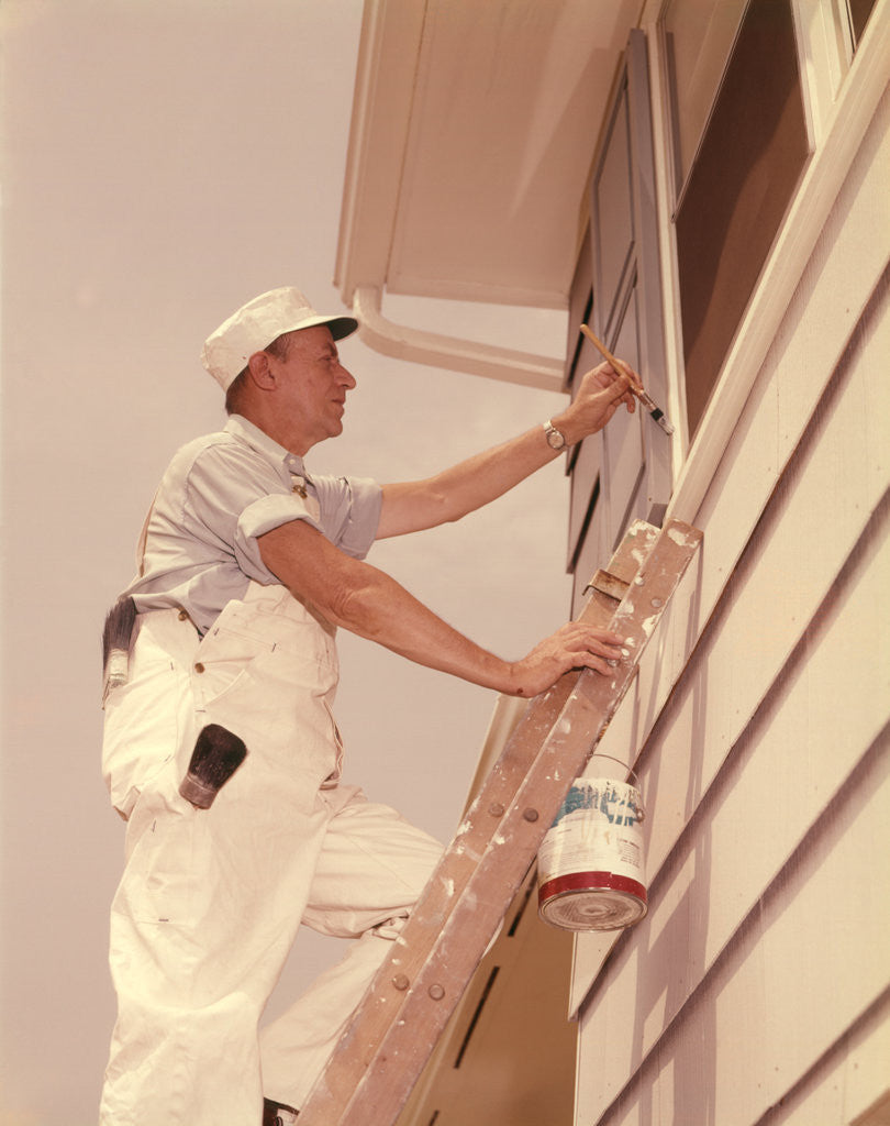 Detail of 1950s 1960s Man House Painter Up Ladder Painting Window Shutter by Corbis