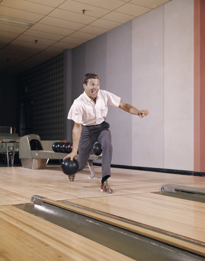 Detail of 1960s Man Bowling Indoor About To Release Ball In Alley by Anonymous