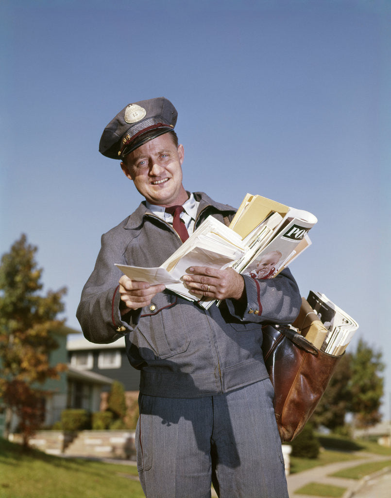Detail of 1960s Mailman Holding Letters Mail Leather Mailbag In Suburban Neighborhood by Anonymous