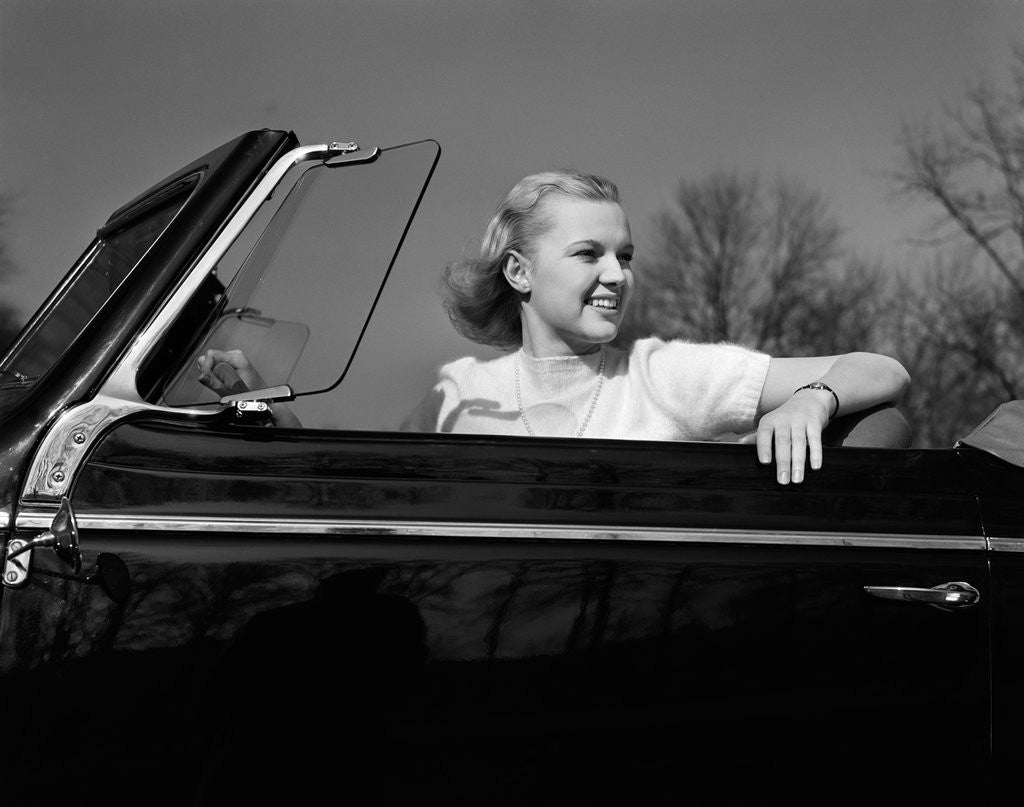 Detail of 1930s 1940s Pretty Teenage Woman Sitting In Convertible Automobile Driver Seat by Anonymous