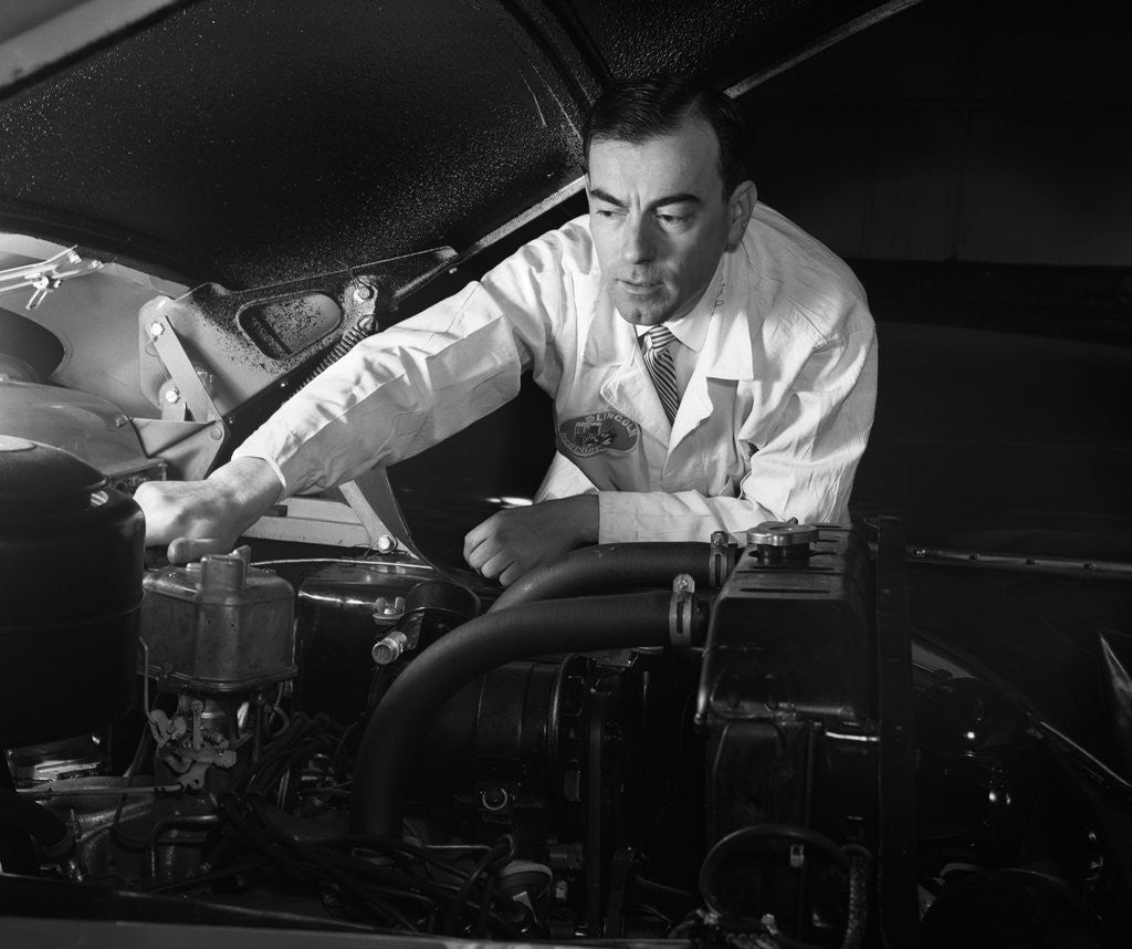 Detail of 1950s Man Automotive Mechanic Servicing Car Engine by Corbis