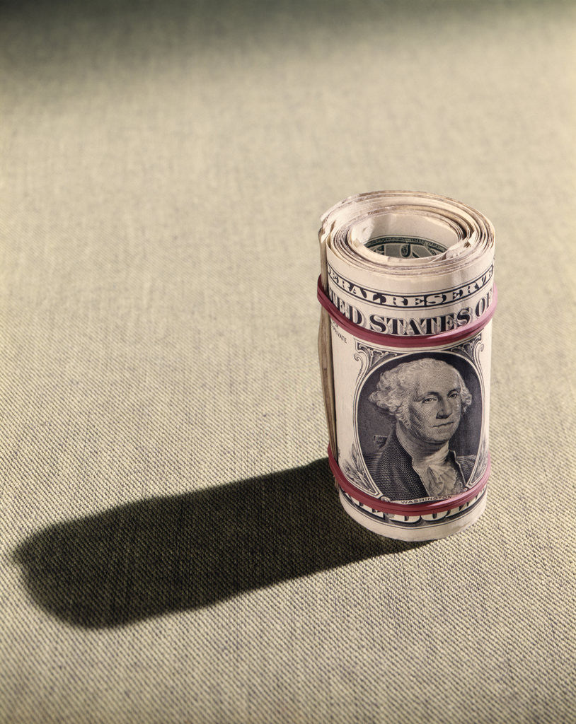 Detail of 1970s Red Elastic Rubber Bands Around Roll Of One Dollar Bills by Anonymous