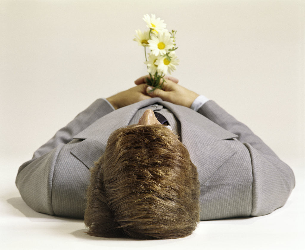 Detail of 1970s Man Lying Down Pushing Up Daisies by Anonymous