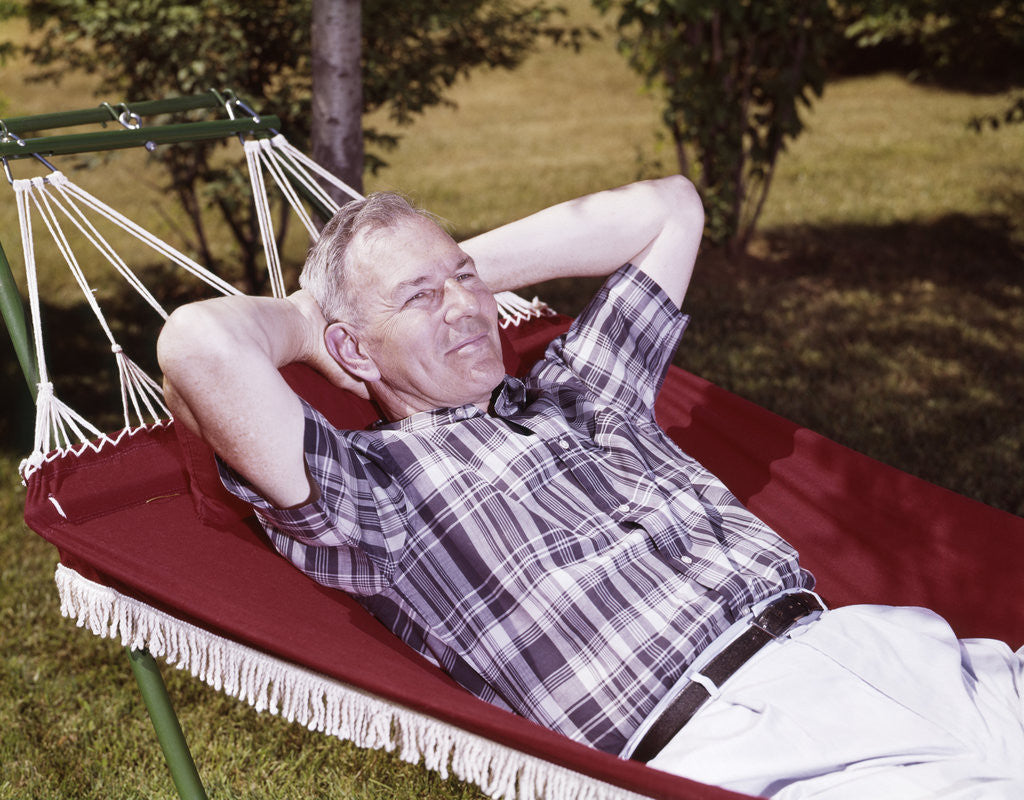 Detail of 1960s Older Man Lying In Hammock In Backyard Retired Lifestyle Leisure by Corbis
