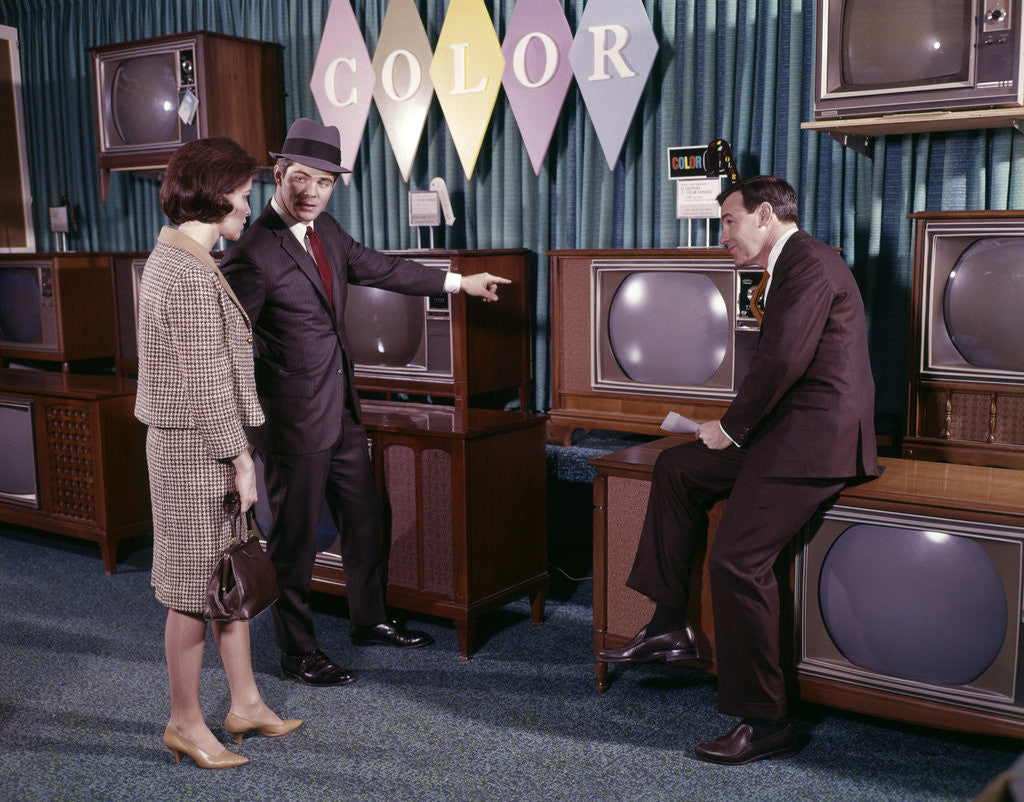 Detail of 1960s Couple Man Woman Talking To Salesman In Color Television Set Sales Department by Anonymous