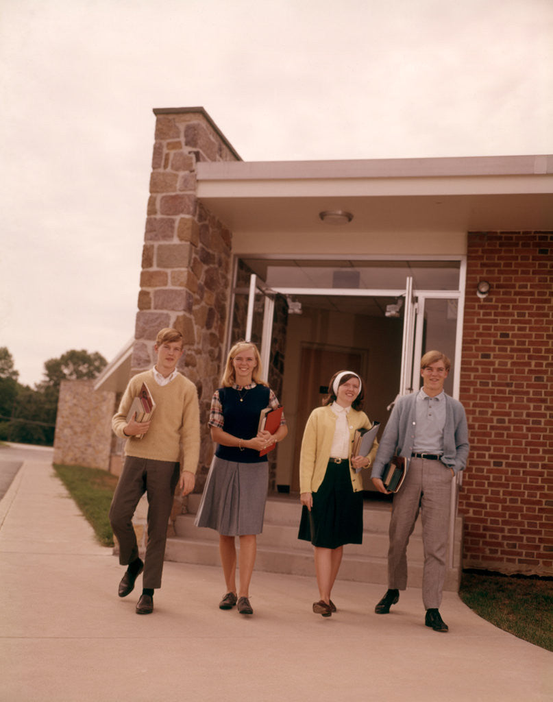 Detail of 1960s Four Teenage Students Walking Out Of Suburban High School Building Carrying Books by Anonymous