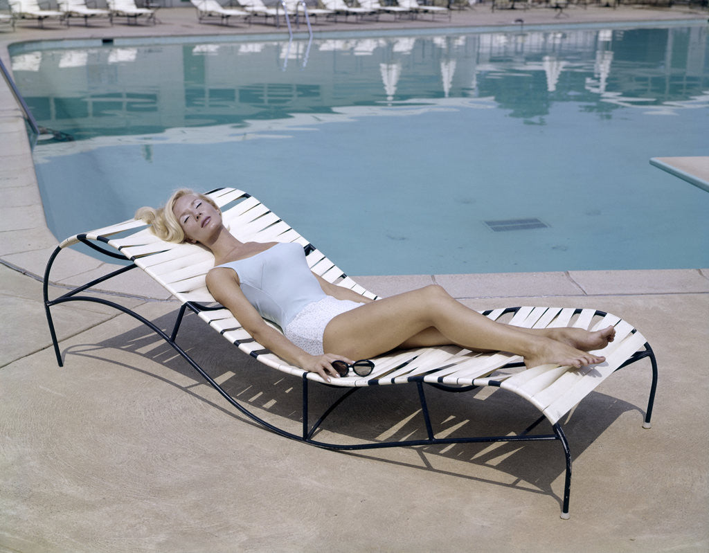 Detail of 1960s Elegant Tall Woman In Bathing Suit Reclining On A Lounge Chair By Swimming Pool by Corbis