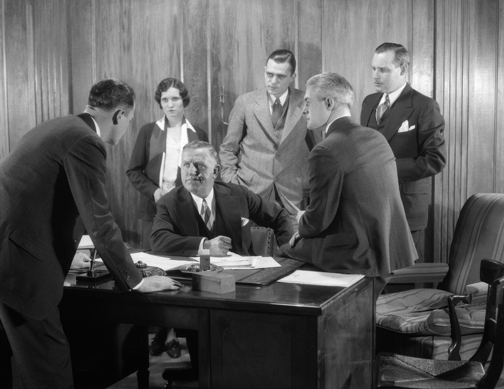 Detail of 1930s Worried Business Group In Office Meeting Around The Boss' Desk by Anonymous