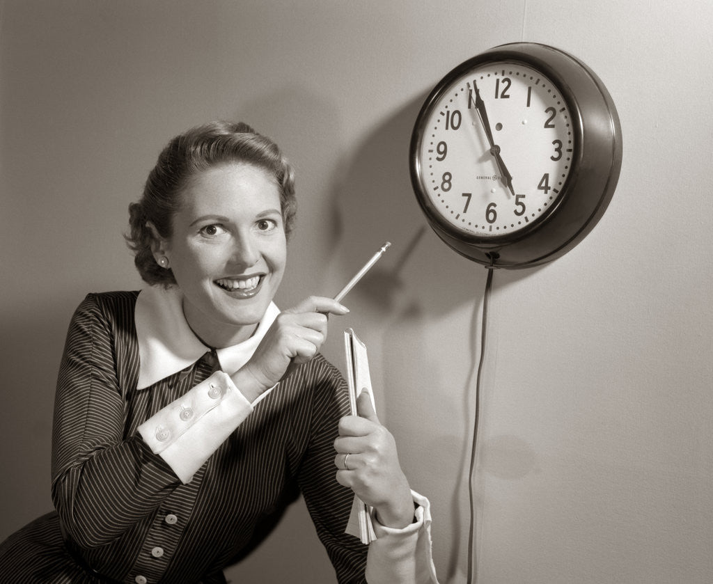 Detail of 1950s Woman Holding Steno Pad Pointing With Pencil To Clock 5 Minutes Till Quitting Time by Anonymous