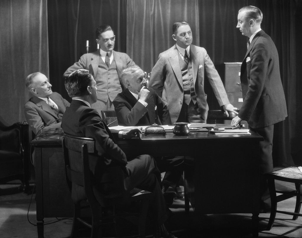 Detail of 1930s Five Older Businessmen Meeting Around A Desk Listening To A Sixth Younger Man Speak by Anonymous