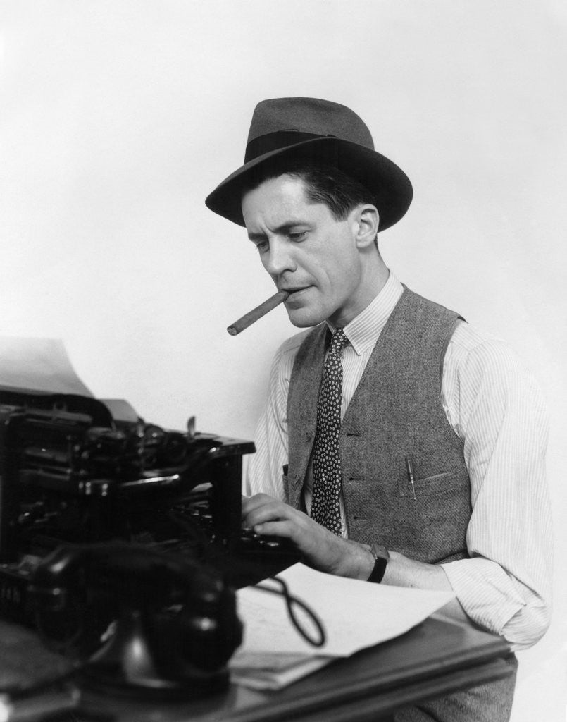 Detail of 1930s Man Newspaper Reporter Wearing Hat Typing Smoking Cigar by Corbis
