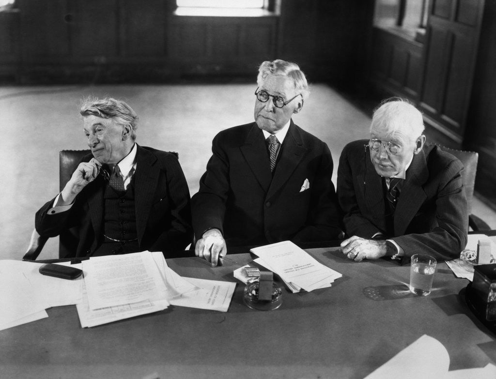 Detail of 1930s 1940s Elderly Businessmen Sitting At Conference Table With Attention Directed To Speaker Not Shown by Anonymous