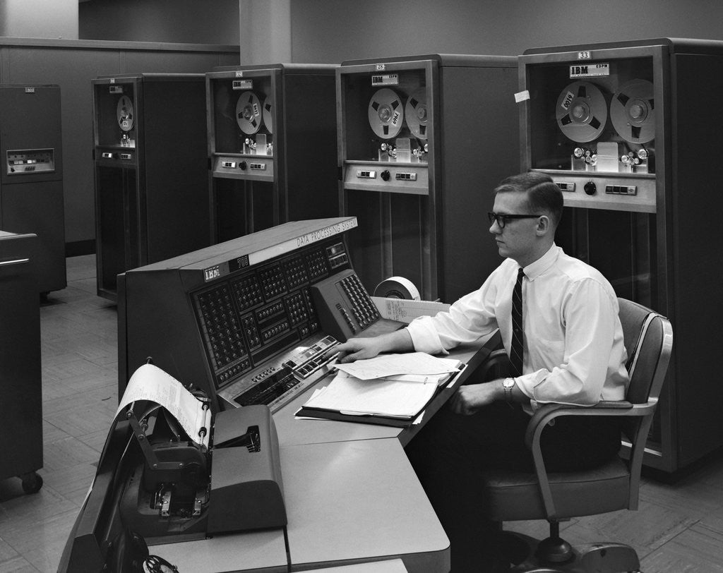 Detail of 1960s Man In Shirt Tie and Thick Black Glasses Working With IBM Data Processing System by Anonymous