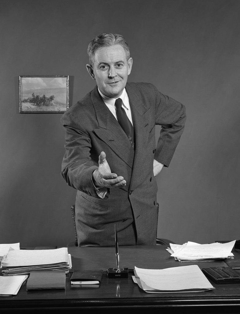 Detail of 1950s Man Businessman Salesman Reaching Across Desk To Shake Hands by Anonymous