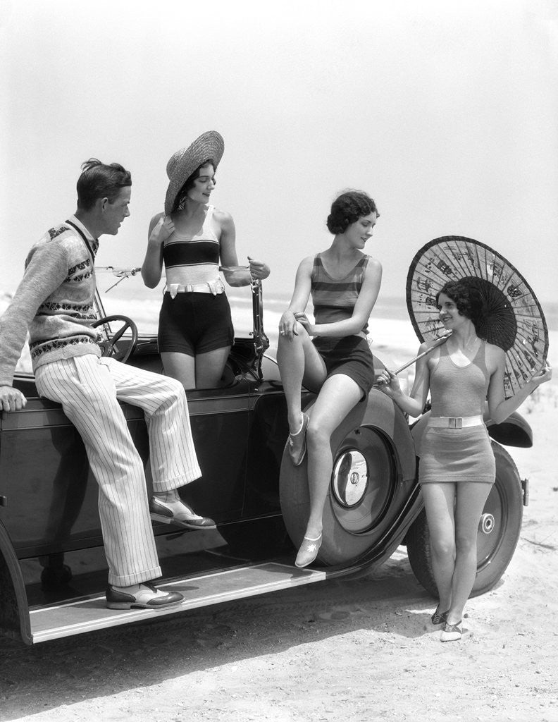 Detail of 1920s 1930s Man And Three Women In Beach Clothes Or Bathing Suits Posing With Car On Running Board by Corbis