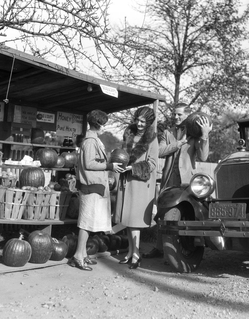 Detail of 1920s Couple Women Man At Roadside Produce Stand Buying Pumpkins by Anonymous