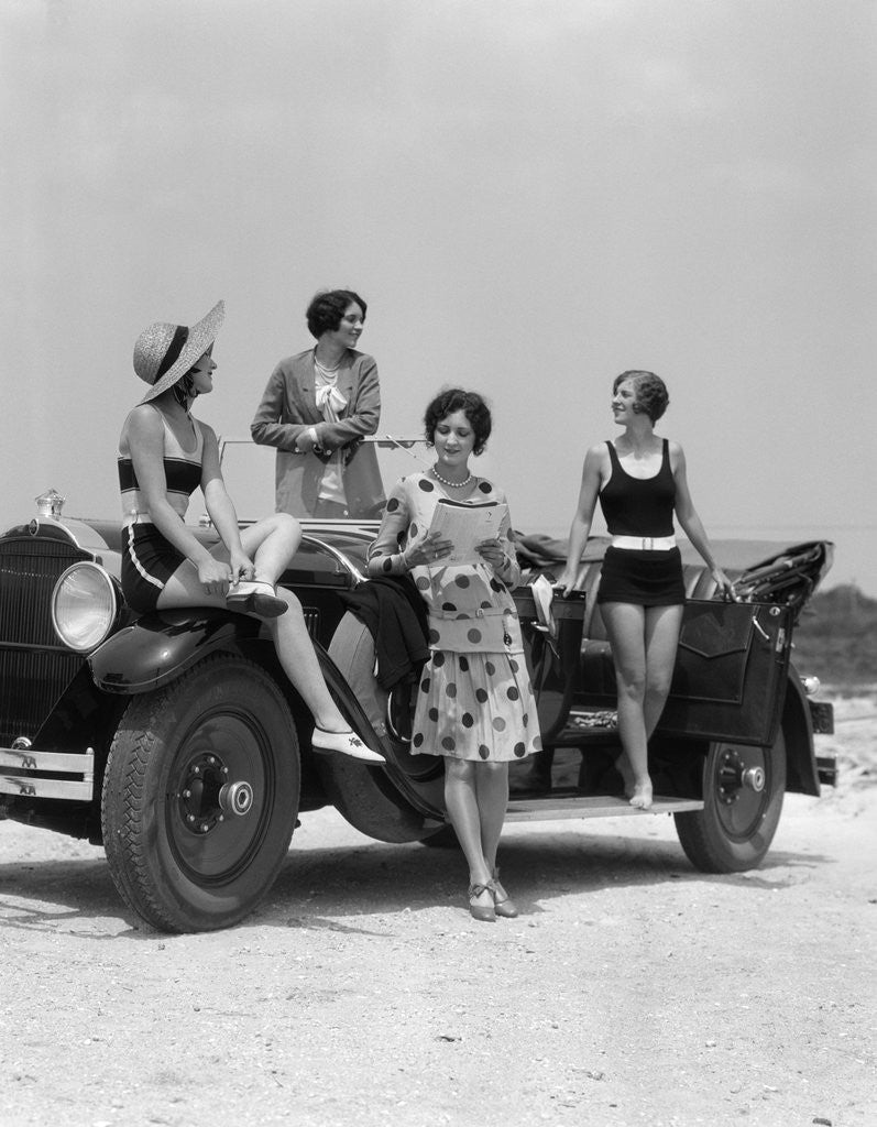 1920s 1930s Four Women In Dresses And Bathing Suits Gathered Around Convertible Touring Car At Seashore by Corbis