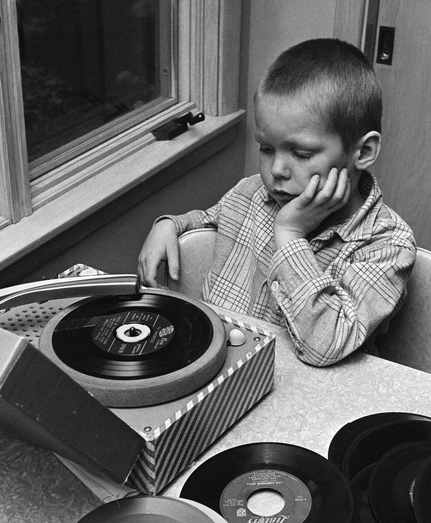 Detail of 1960s 1970s Boy With Buzz Haircut Listening To Music On Portable 45 RPM Phonograph Record Player by Corbis