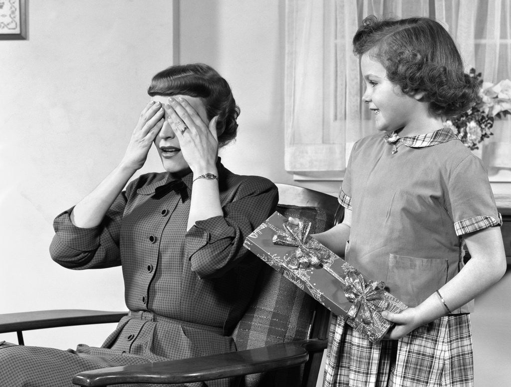 Detail of 1950s Woman Mother Hands Covering Eyes As Girl Daughter Gives Her A Gift Present by Anonymous