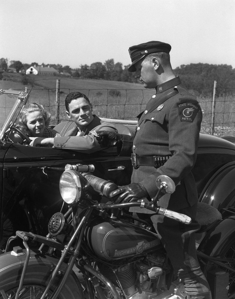 Detail of 1930s Couple In Convertible Coupe Stopped By Motorcycle Cop Checking License Of Driver by Anonymous
