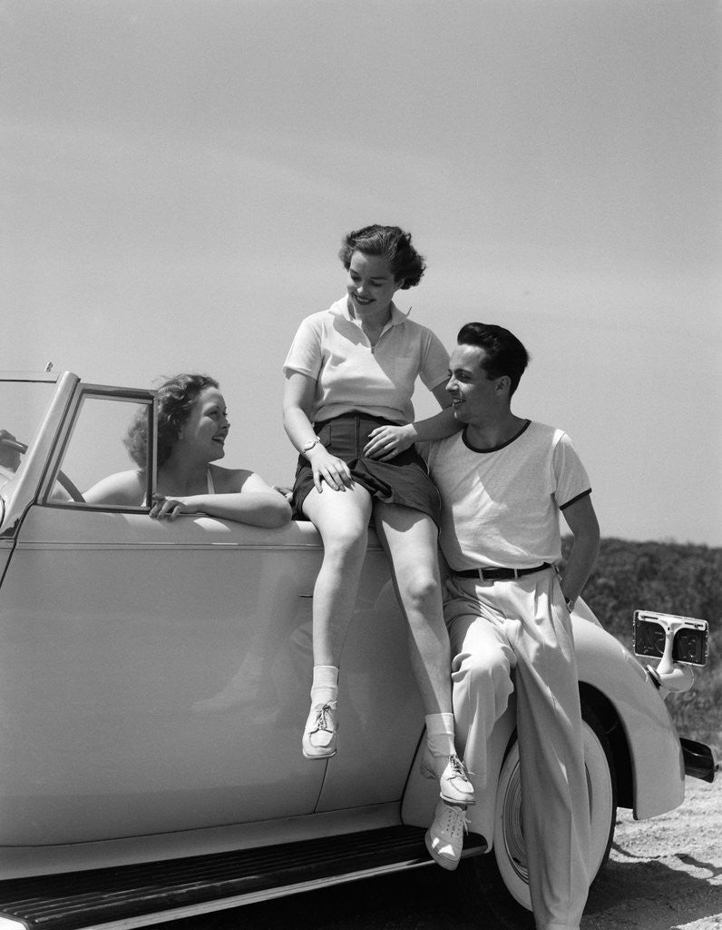 Detail of 1930s Friends Sitting With Convertible Roadster Automobile Talking Together At Seashore by Anonymous