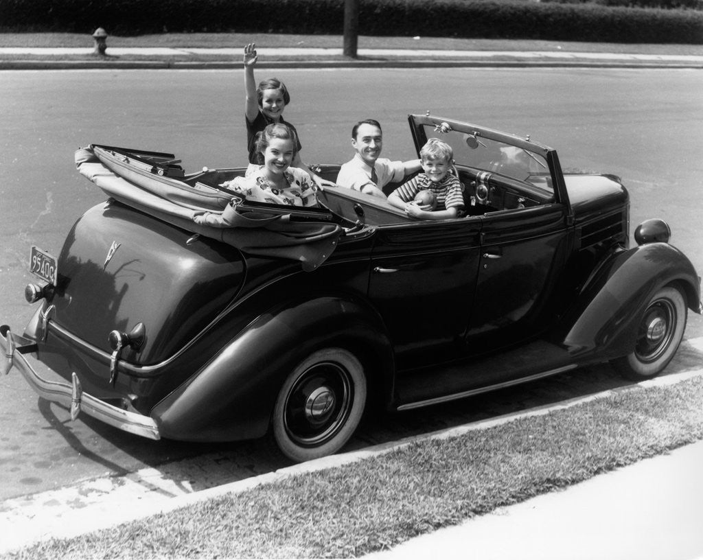 Detail of 1940s Family Of Four In Convertible Ford V-8 Sedan At Camera by Anonymous