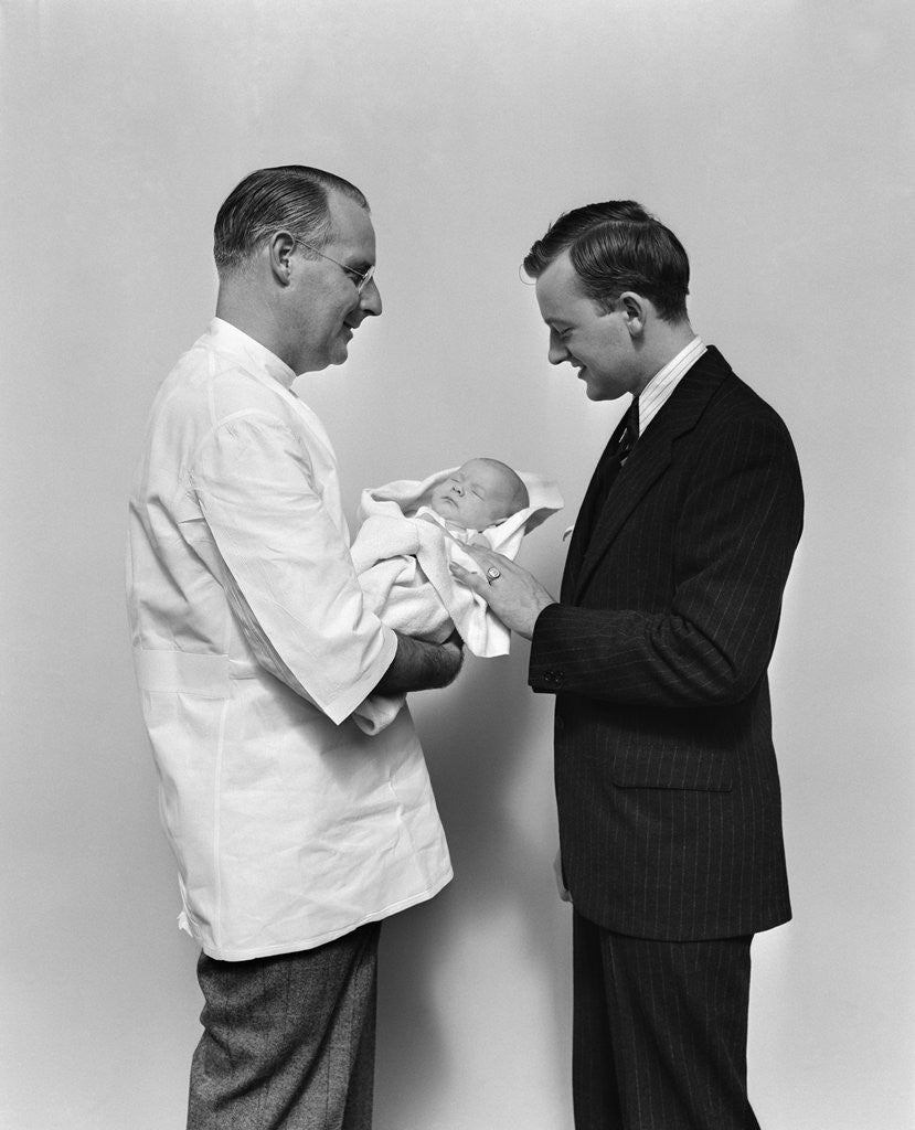 Detail of 1930s 1940s Man Doctor Showing New Born Infant Baby To Proud Father by Corbis